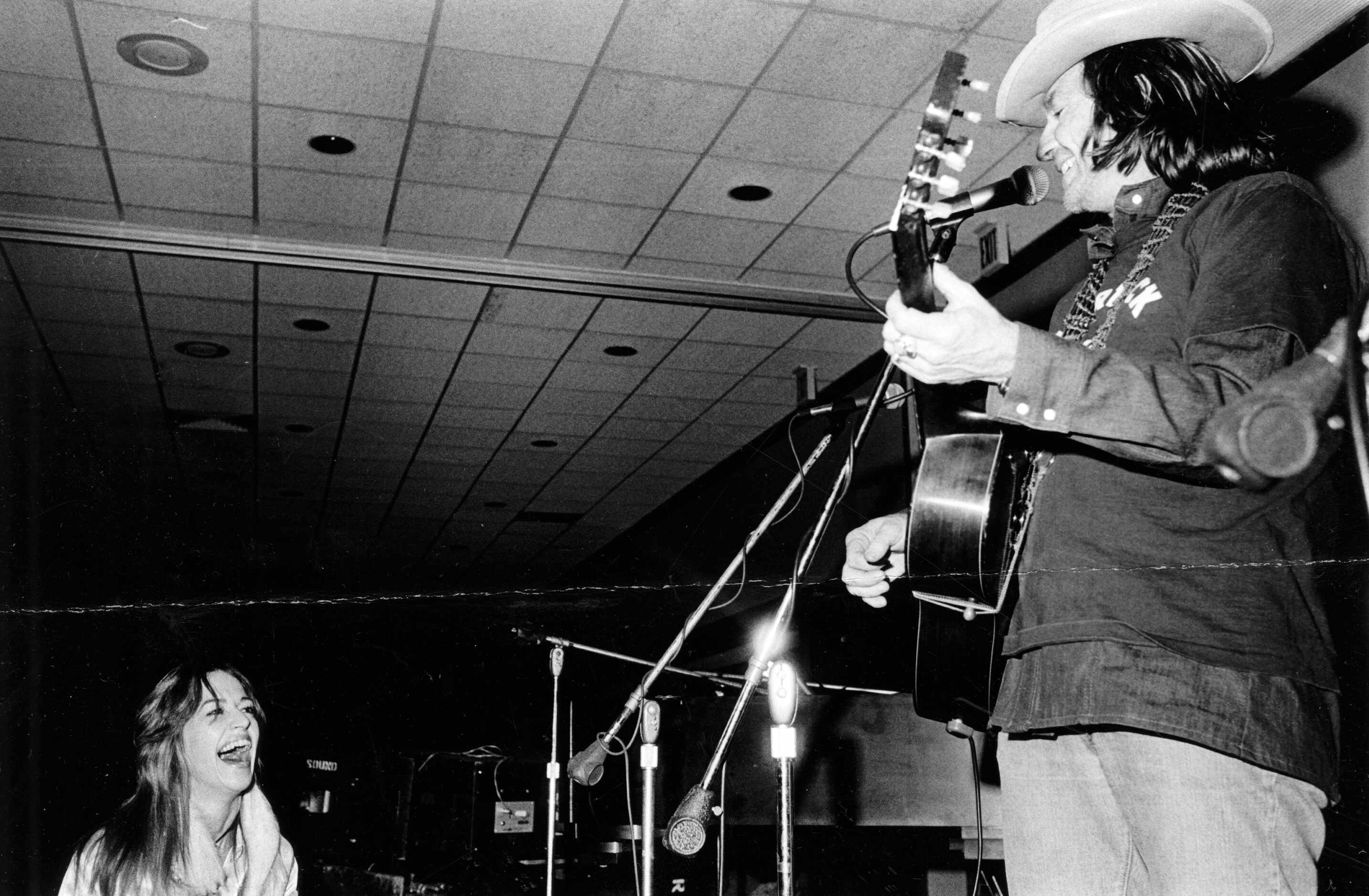 1975 - You can't keep a Willie Nelson fan down. A room full of them tried to contain their...