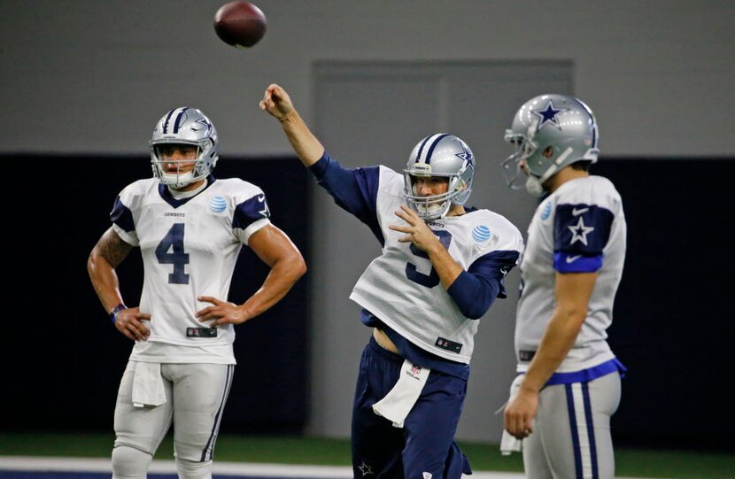 Dallas Cowboys quarterback Tony Romo (9) throws a pass as quarterback Dak Prescott (4) looks...