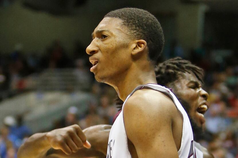 Mansfield Timberview's Chris Mullins (24) gets a reaction from teammate William Owens (32)...
