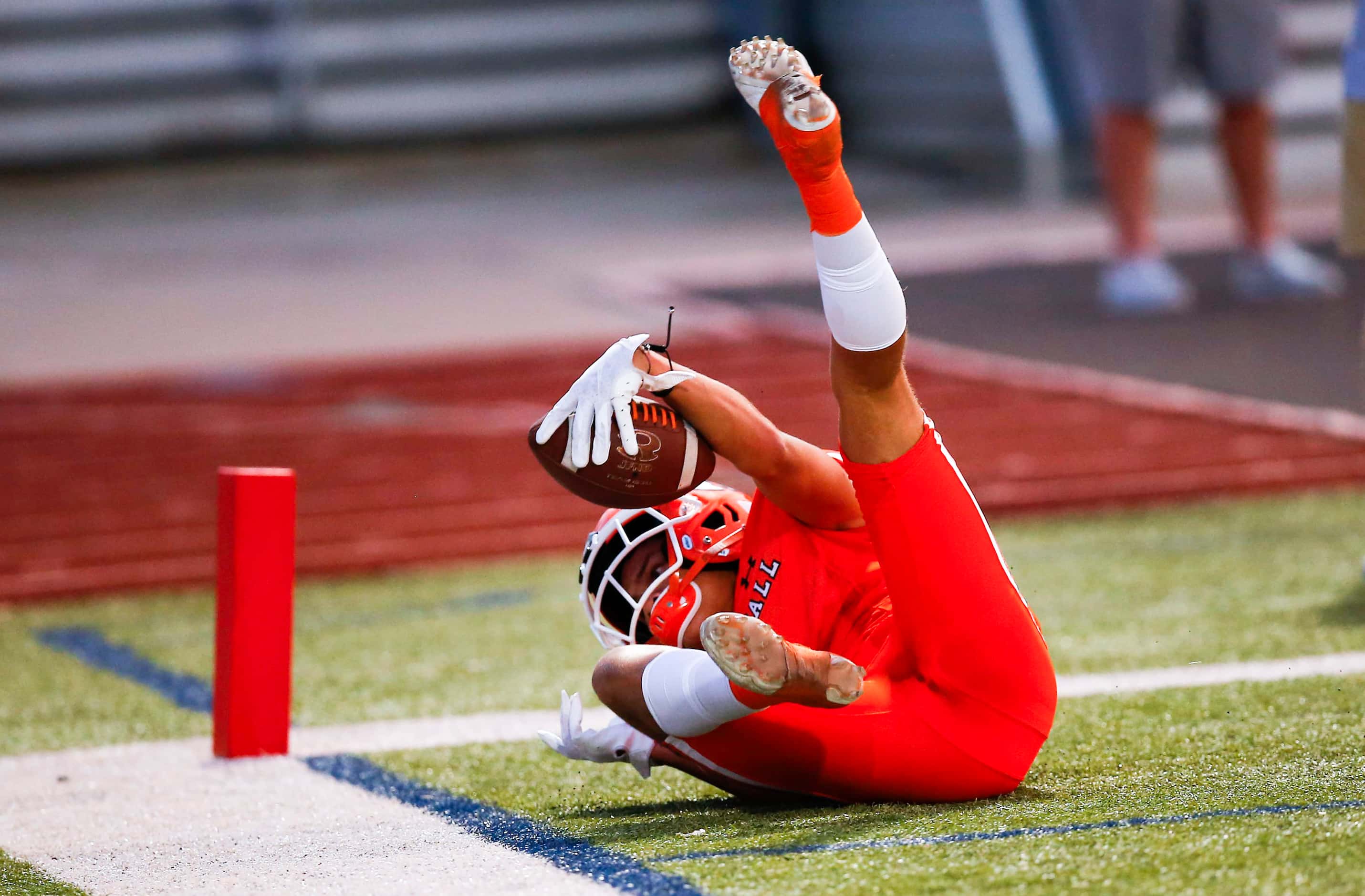 Rockwall junior wide receiver Aiden Meeks (1) scores a touchdown during the first half of a...