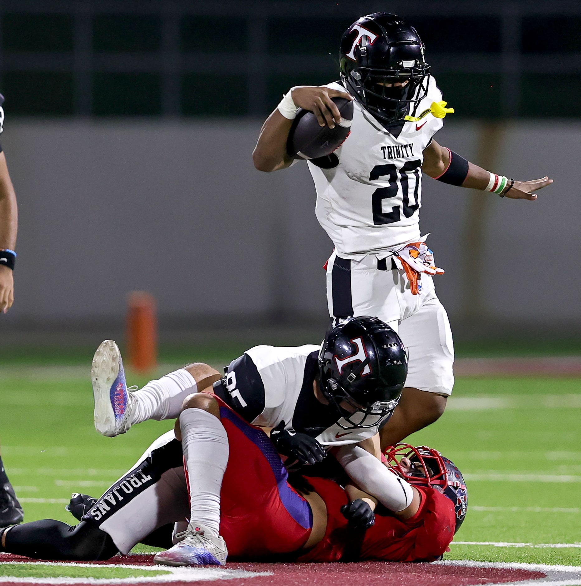 Trinity running back Josh Bell (20) is pulled down by Justin Northwest linebacker Will...