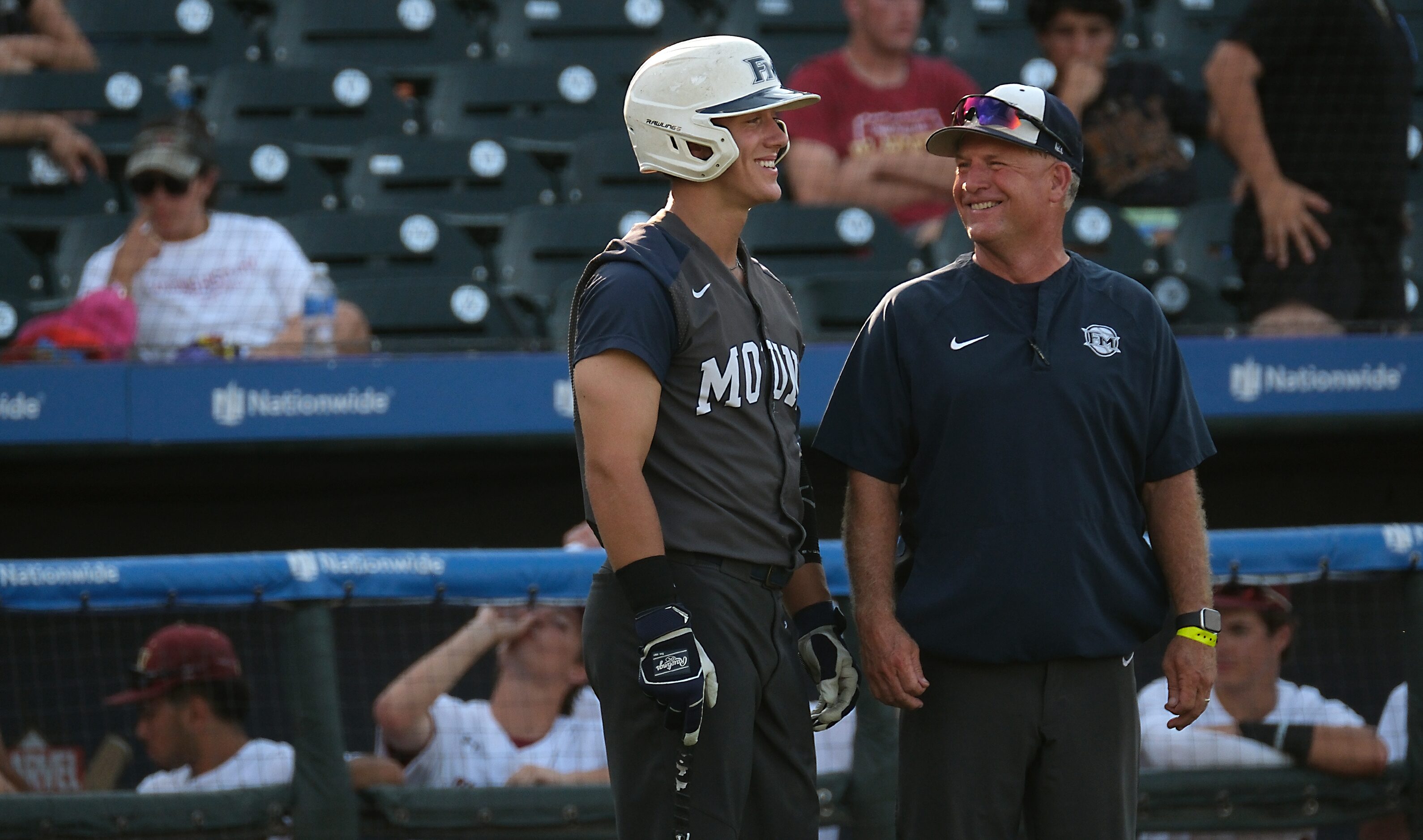 Flower Mound coach, Danny Wallace, and Sam Erickson, (21), share a laugh during a timeout...