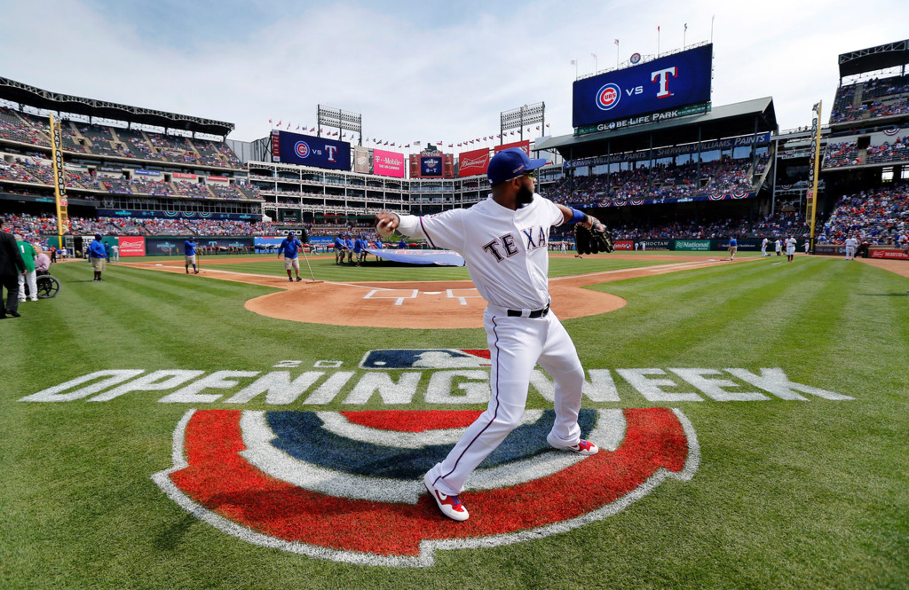 Texas Rangers shortstop Elvis Andrus warms up behind home plate before taking the field...