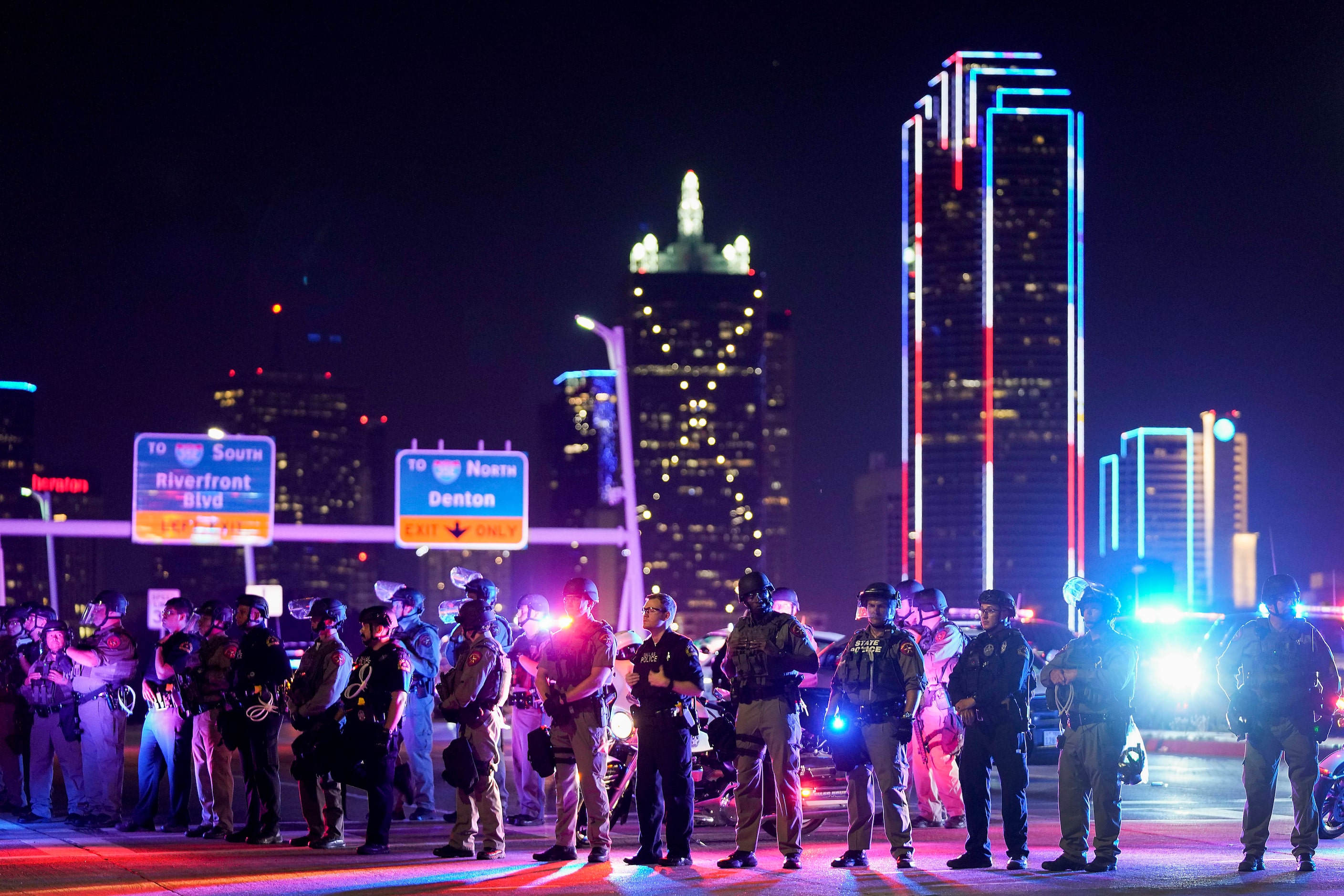 Law enforcement officers block the western side of the Margaret Hunt Hill Bridge while...