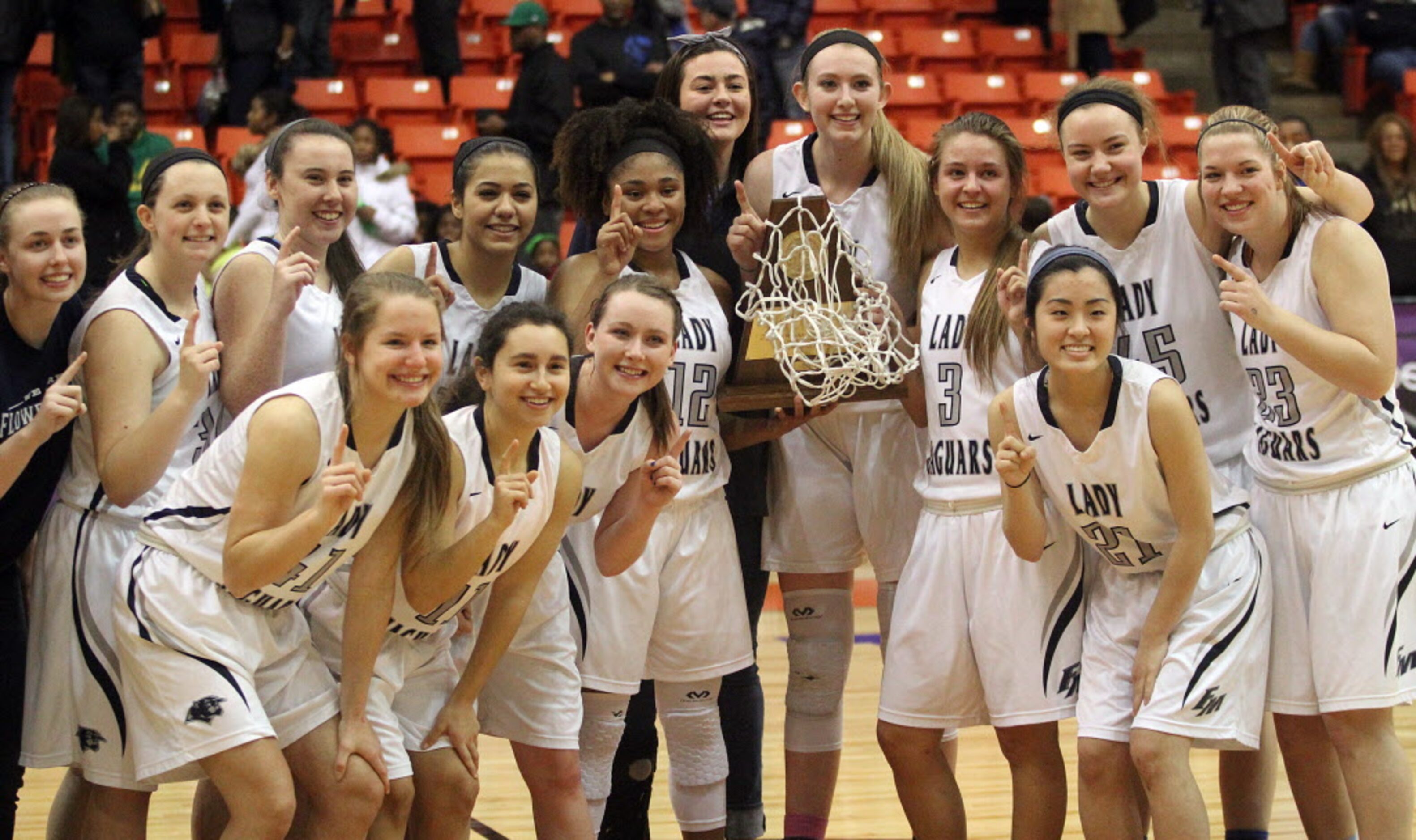 The Flower Mound High School girls basketball team poses with their trophy after defeating...