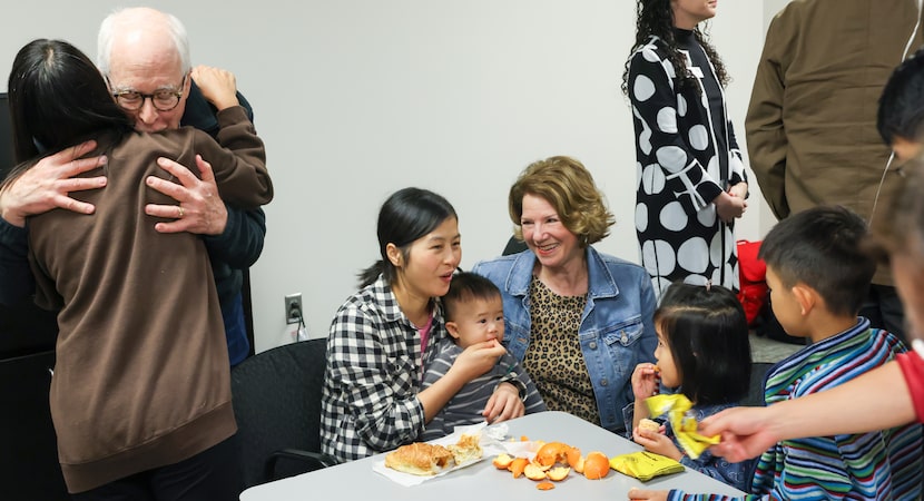 Tyler resident Roger Conaway (left) embraces an asylum-seeker from an overseas Chinese...