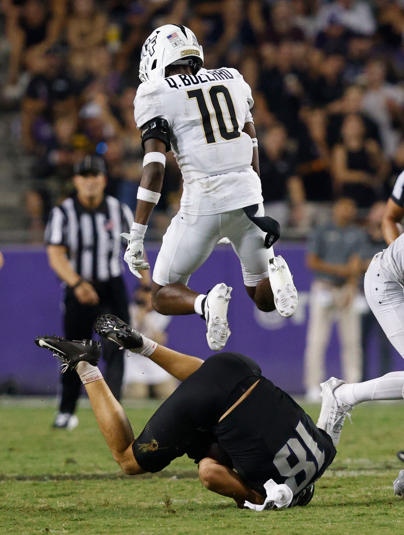 UCF defensive back Quadric Bullard (10) jumps over TCU wide receiver Jack Bech (18) as Bech...