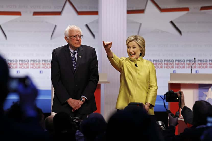 Bernie Sanders and Hillary Clinton  take the stage before the debate. The pair differed on...
