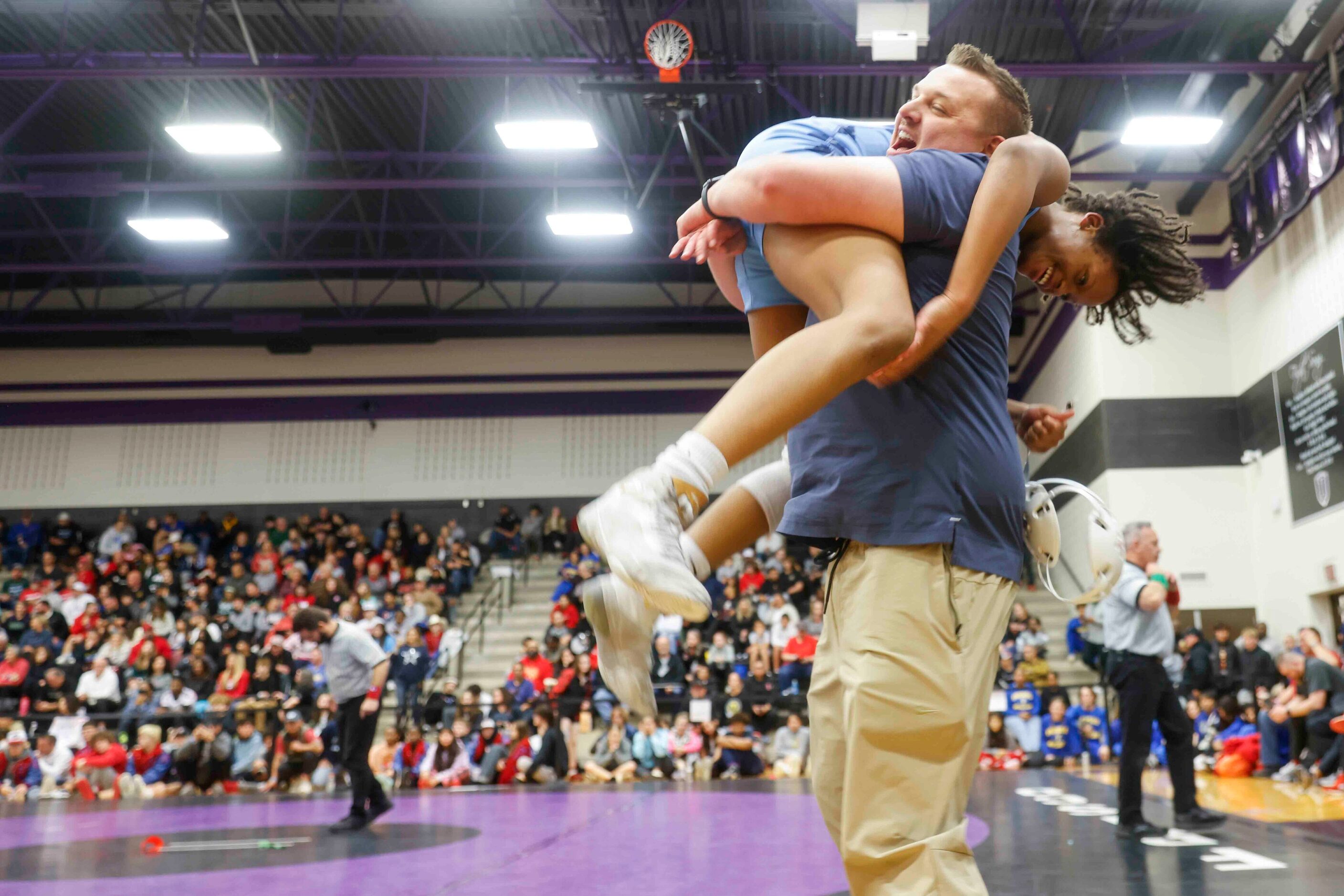 Frisco Emerson assistant coach David Schoen lifts up Summer Rodgers after defeating...