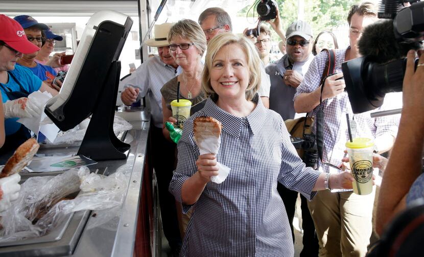Democratic presidential candidate Hillary Rodham Clinton leaves a pork chop stand during a...
