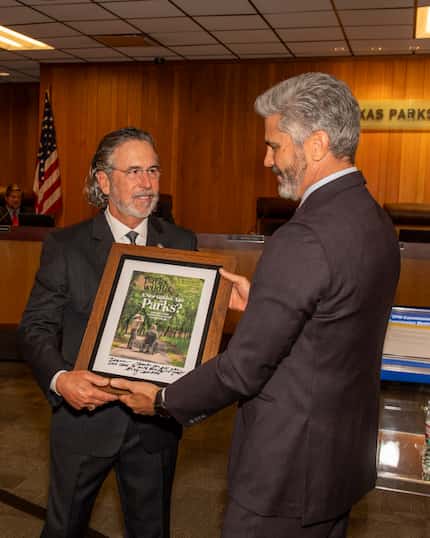 TPWD executive director David Yoskowitz presents outgoing Texas Parks and Wildlife...