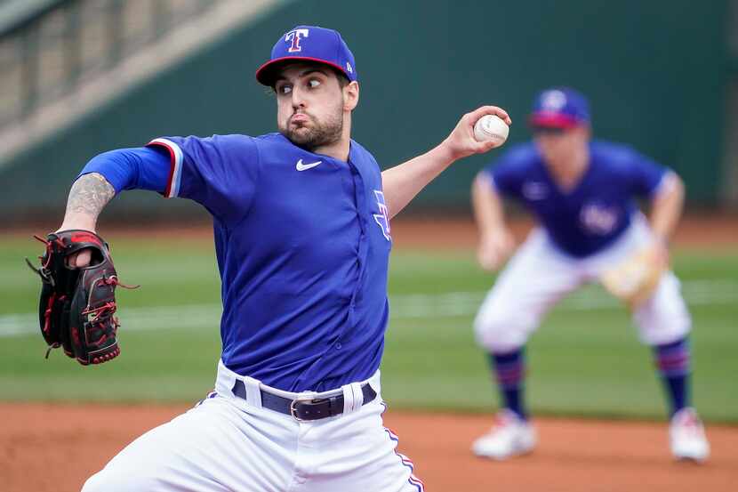 Texas Rangers pitcher Joe Palumbo delivers during the first inning of a spring training game...