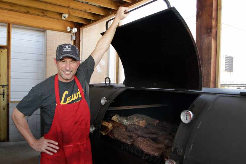 Co-owner Todd David opens the lid on his massive 1000-gallon smoker, Brutus, at Cattleack...