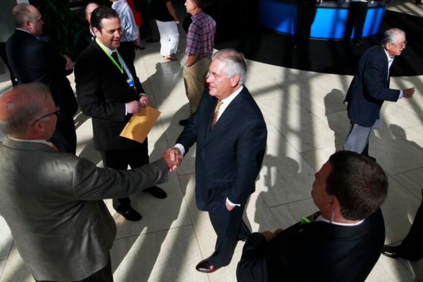 
Exxon Mobil CEO Rex Tillerson,  greeting shareholders Wednesday, pushed back against...