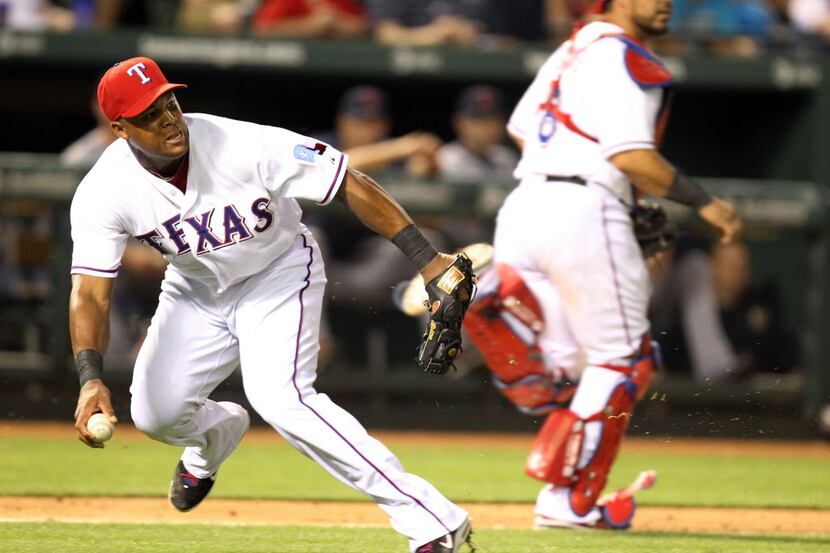 Texas third baseman Adrian Beltre picks up Omar Infante's dribbler in the sixth inning, but...