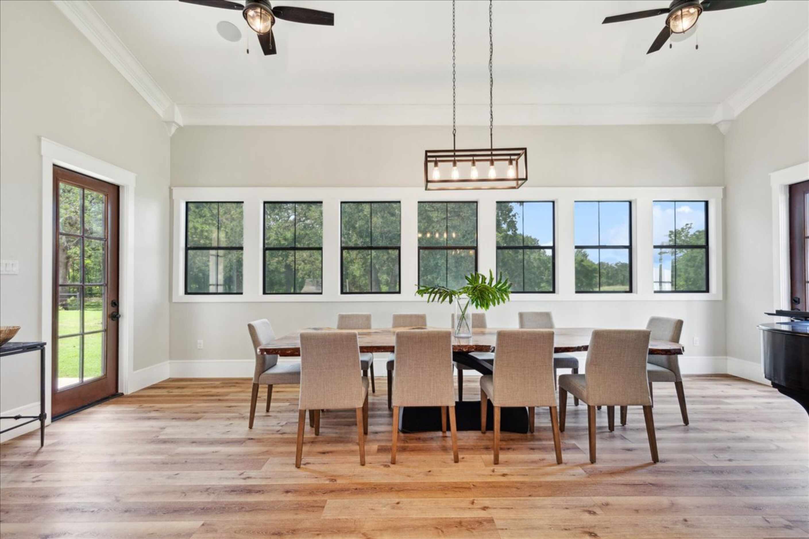 Large dining area with a wall of windows