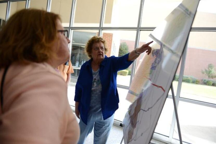 
Rockwall resident Illa Prusha points to a location on a map which details the proposed...