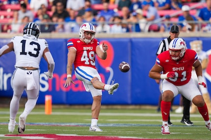 SMU punter Isaac Pearson (49) punts during the first half of an NCAA football game against...