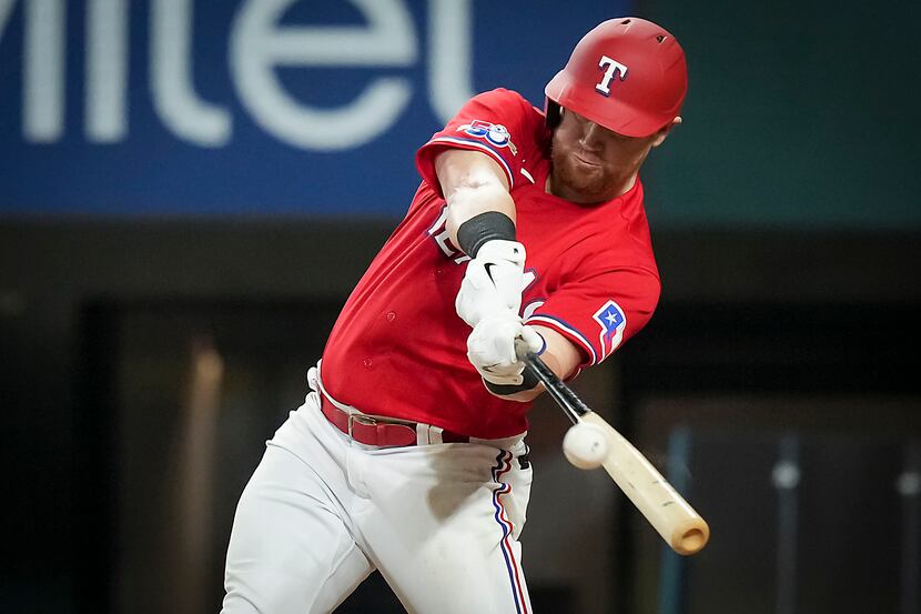 Texas Rangers right fielder Kole Calhoun drives in a run with a double during the sixth...