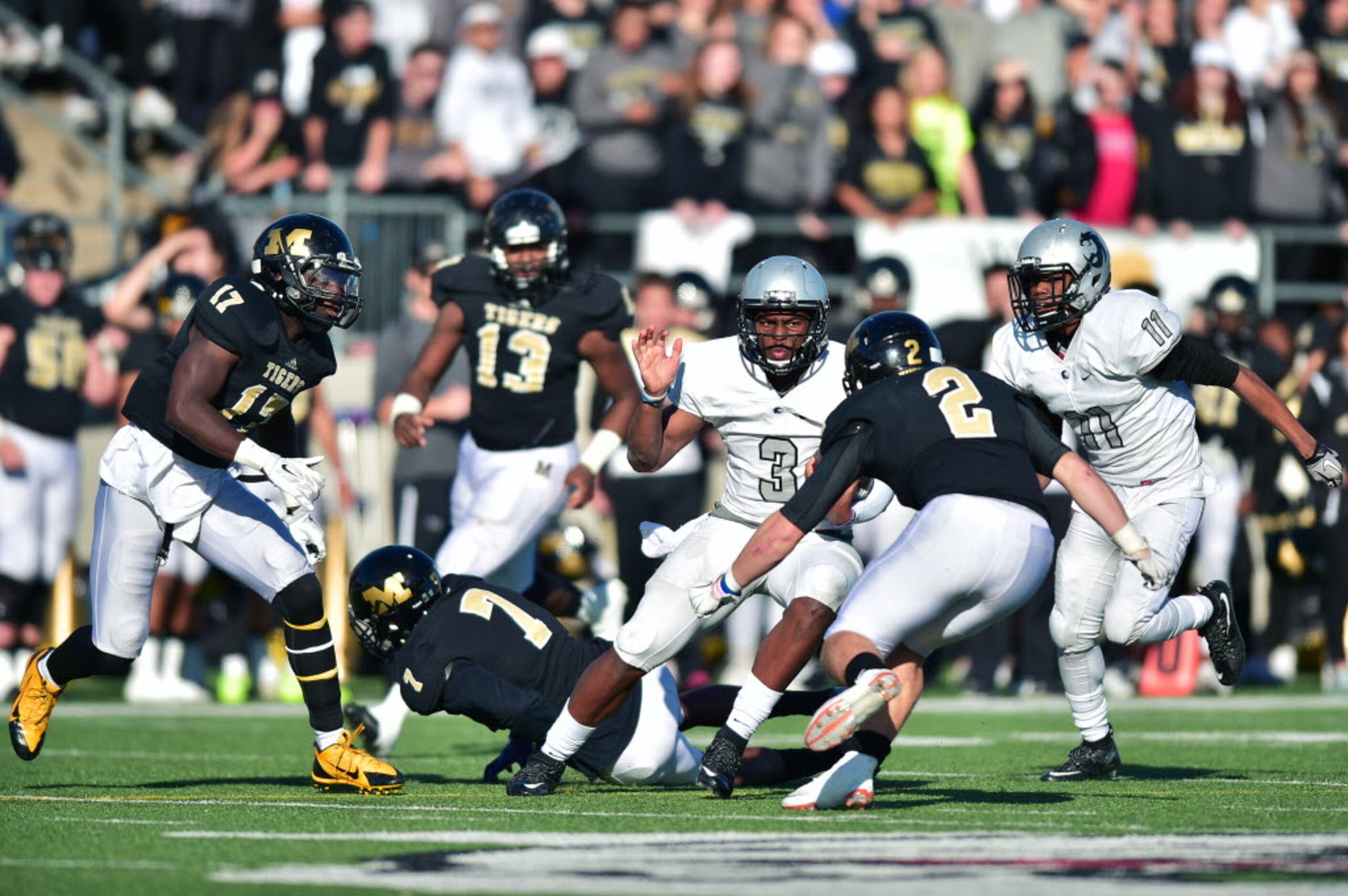 Guyer junior quarterback Shawn Robinson (3) stares down Mansfield senior corner Zayne...