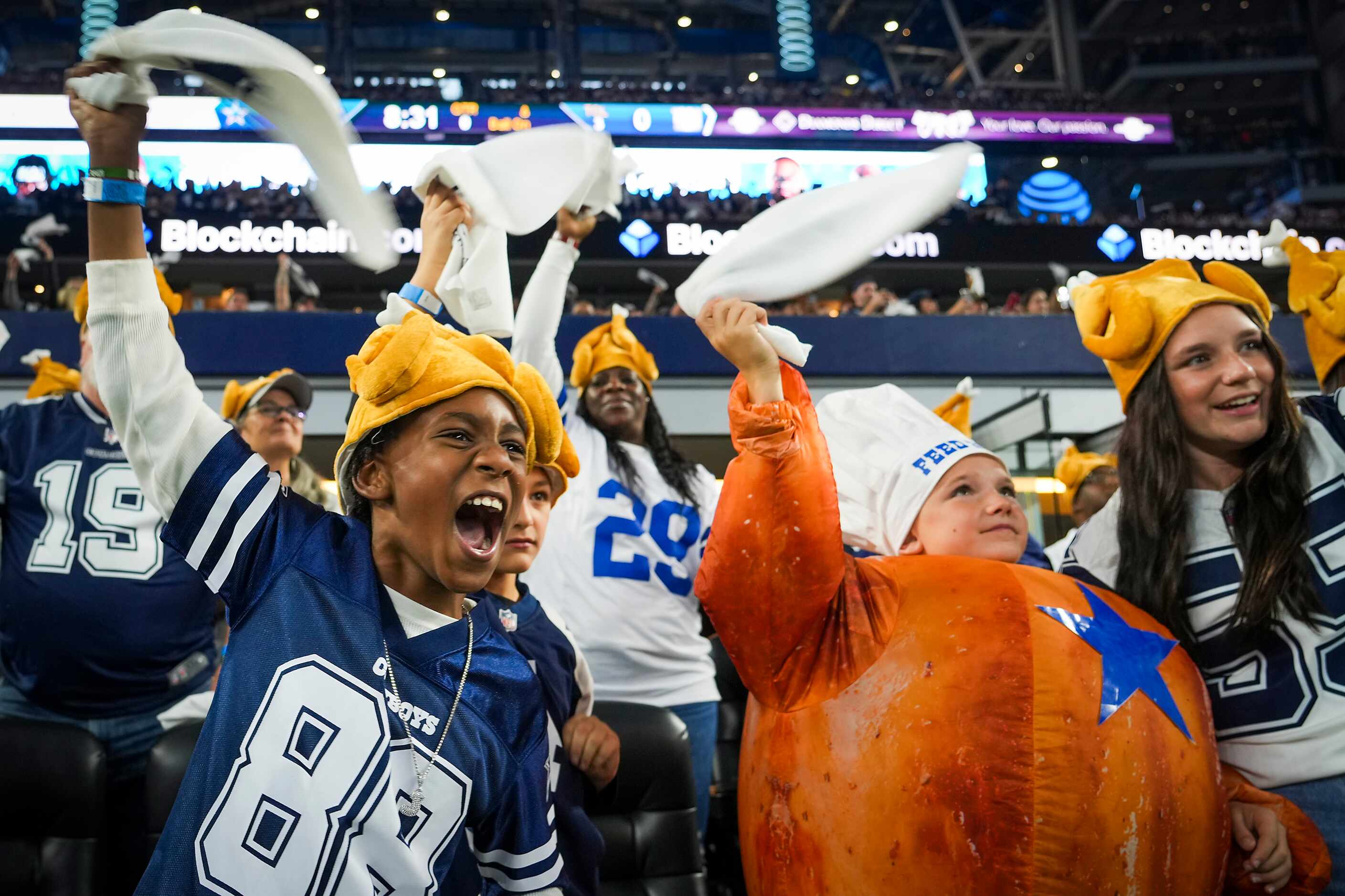 Jayden Lewis (left) and Cason Diantonio  cheer as the Dallas Cowboys take the field to face...
