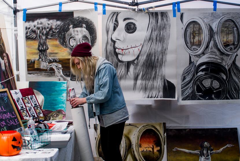 Artist Jamie Rachel organizes the artwork in her booth at ArtsGoggle in 2018. This year's...