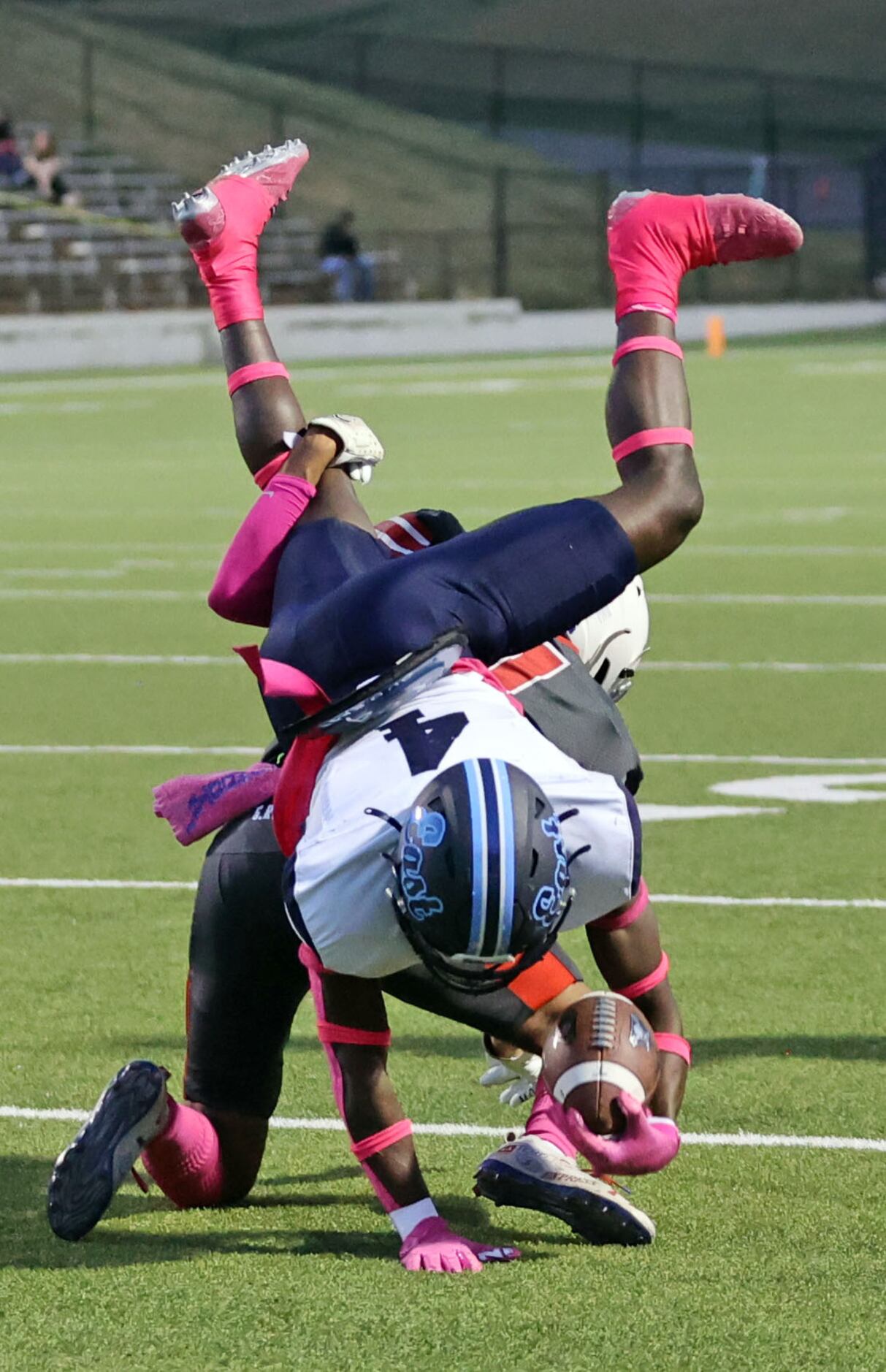 Wylie East high’s Tristan Lee (4) goes over a South Garland High defender for extra yards...