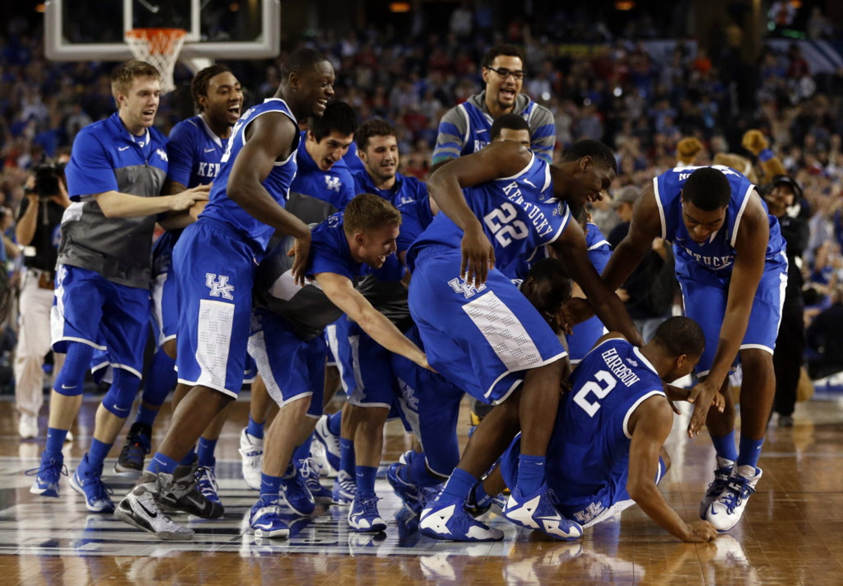 Kentucky Wildcats dog piles Kentucky Wildcats guard Aaron Harrison (2) after defeating the...