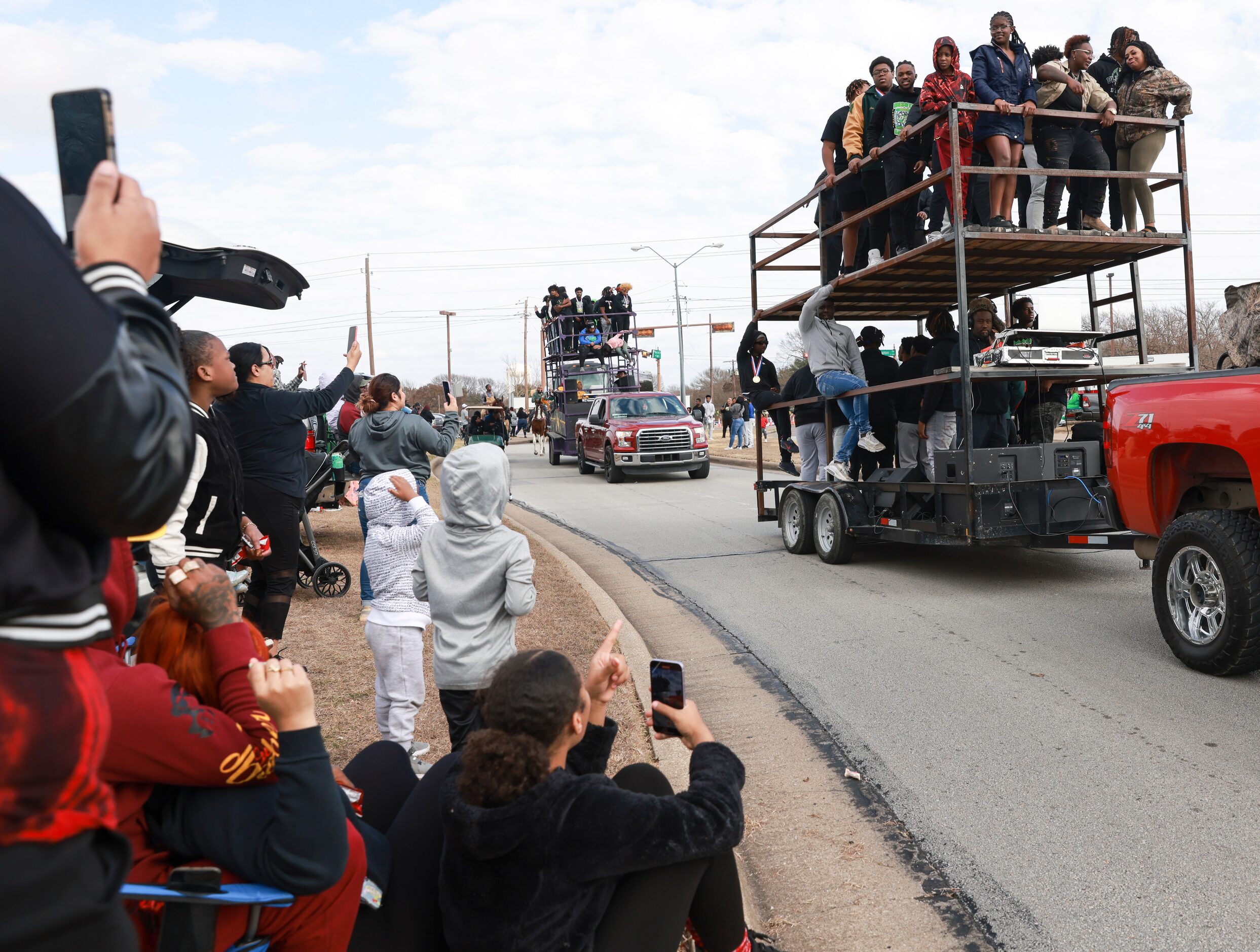 DeSoto High School football players ride on top of a double-decker trailer, Saturday, Jan....