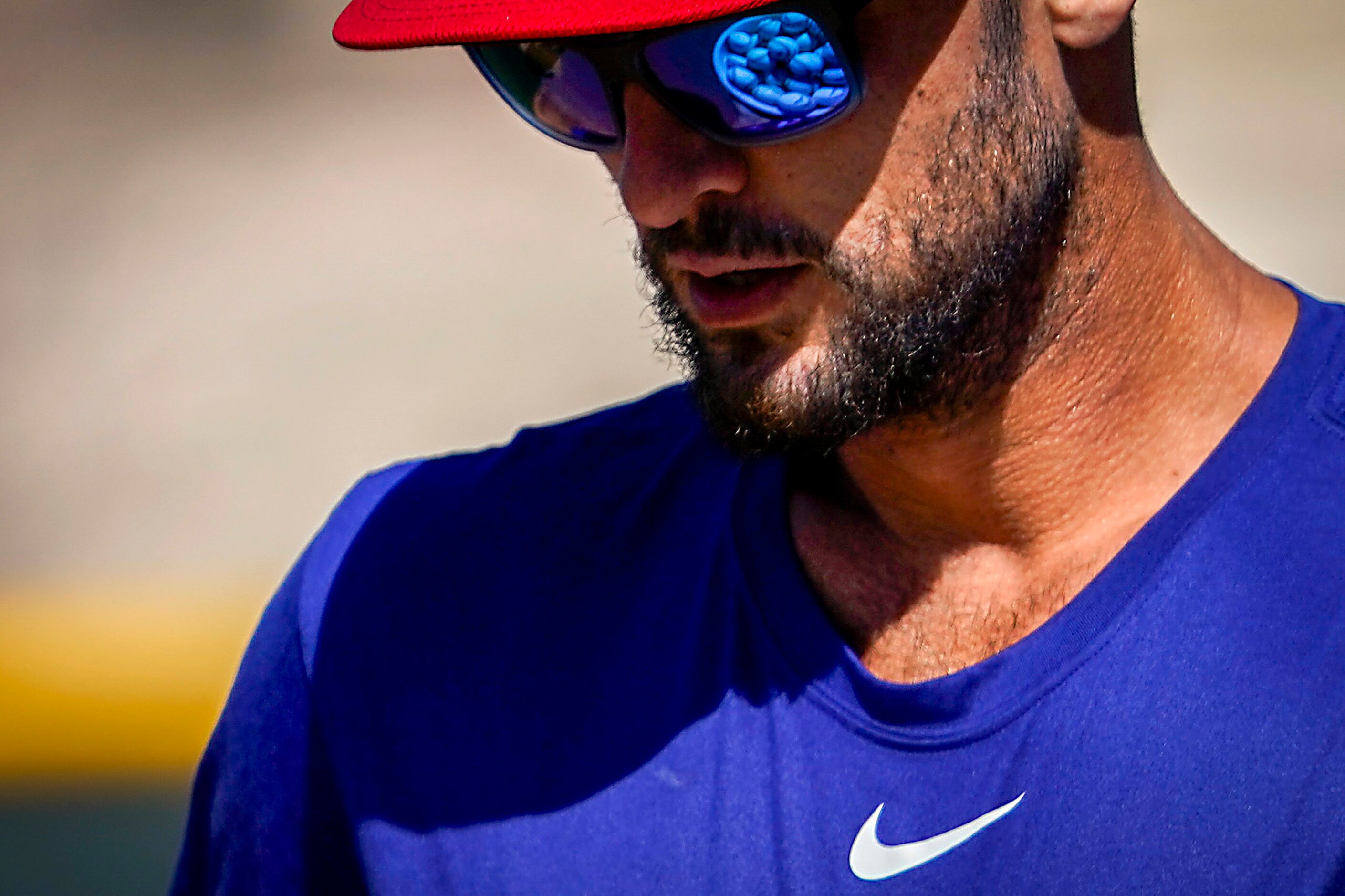 Texas Rangers infielder Greg Bird carries a bucket of baseball from infield practice during...