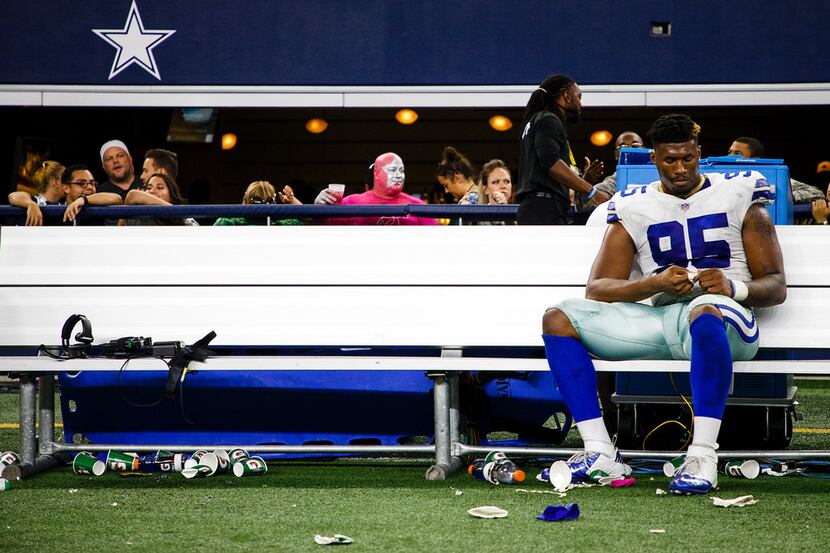 Cowboys defensive tackle David Irving sits on the bench following Dallas' 35-31 loss to the...