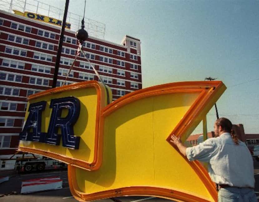 Designer Don Beck helped steady part of the neon sign that would read South Side on Lamar in...