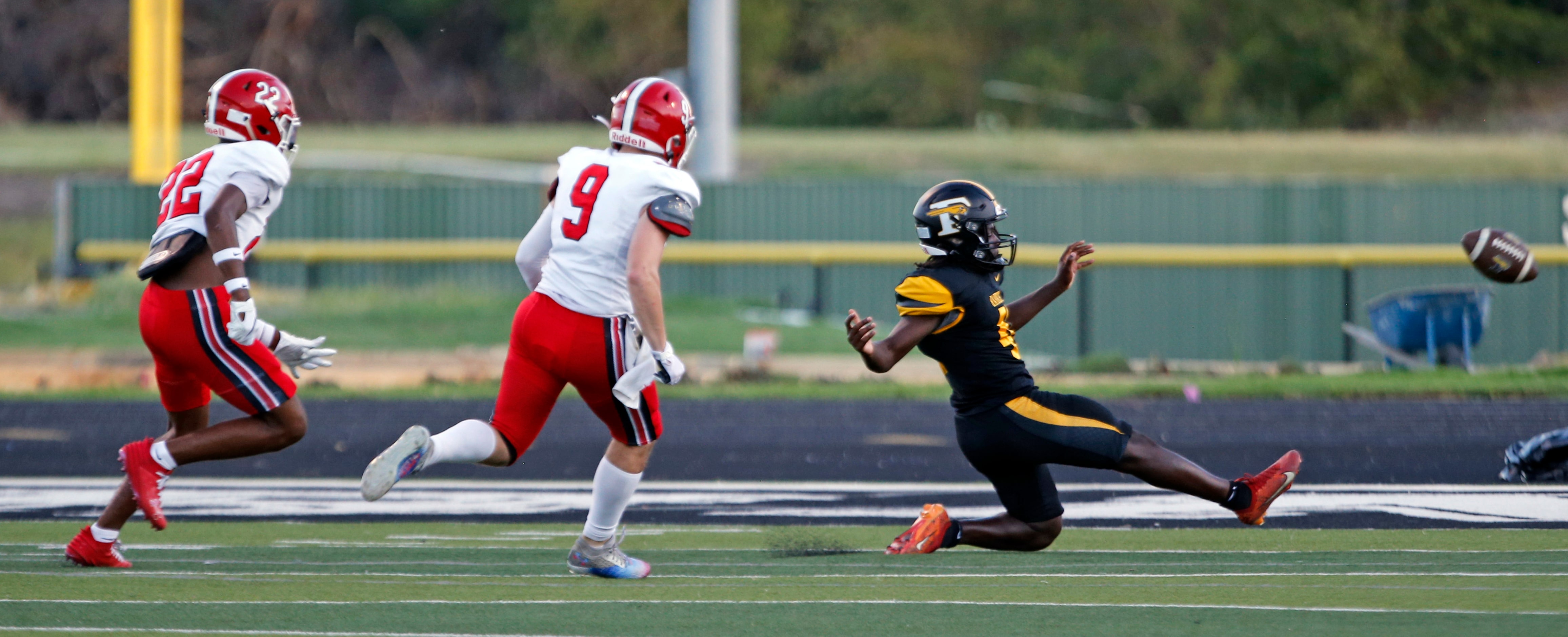 Forney High punter Vincent Hart (41) kicks a bad snap through the end zone for a safety, as...