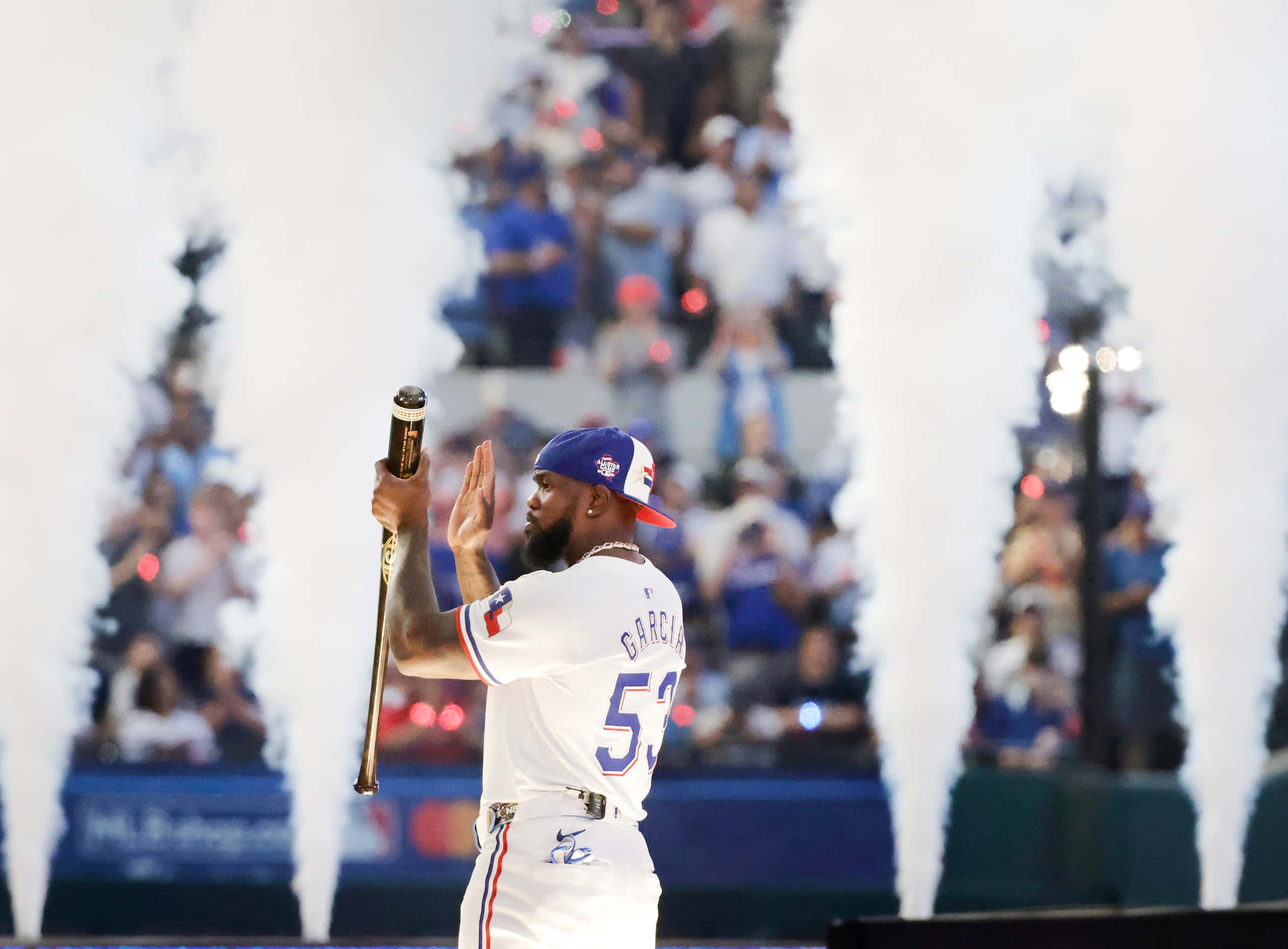 Texas Rangers outfielder Adolis Garcia applauds the fans after being introduced before the...