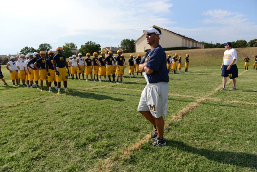 Jeff Smith, McKinney High School head football coach, head football coach, instructs players...