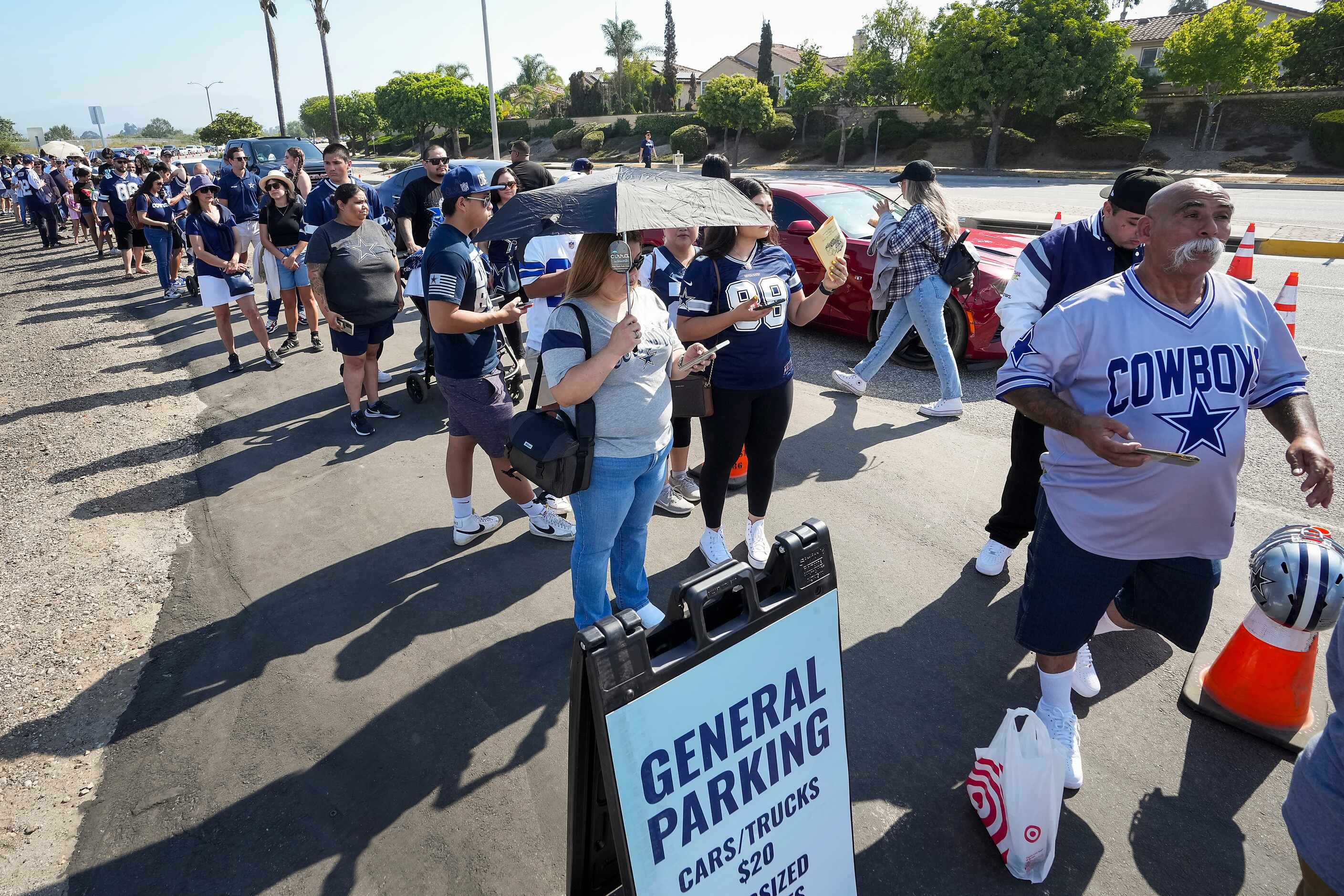 The line of fans to enter opening ceremonies for Dallas Cowboys training camp wraps around...