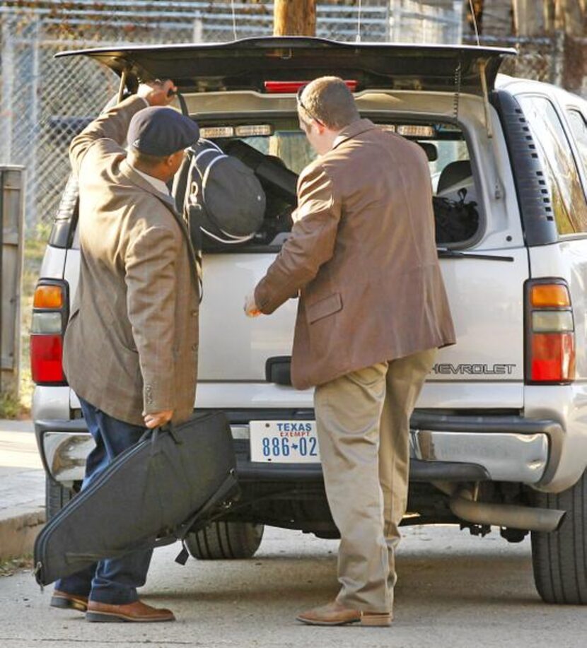 
Dallas police loaded items Wednesday from a Cedars neighborhood duplex where Nick and...