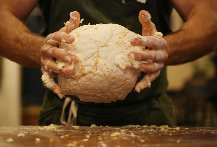 Chef Robert Lyford prepares cheddar biscuits at Patina Green Home and Market in McKinney. 