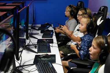 Trey Nsaky, 9, of Frisco, plays an online video game as Stonebriar Country Club in Frisco...