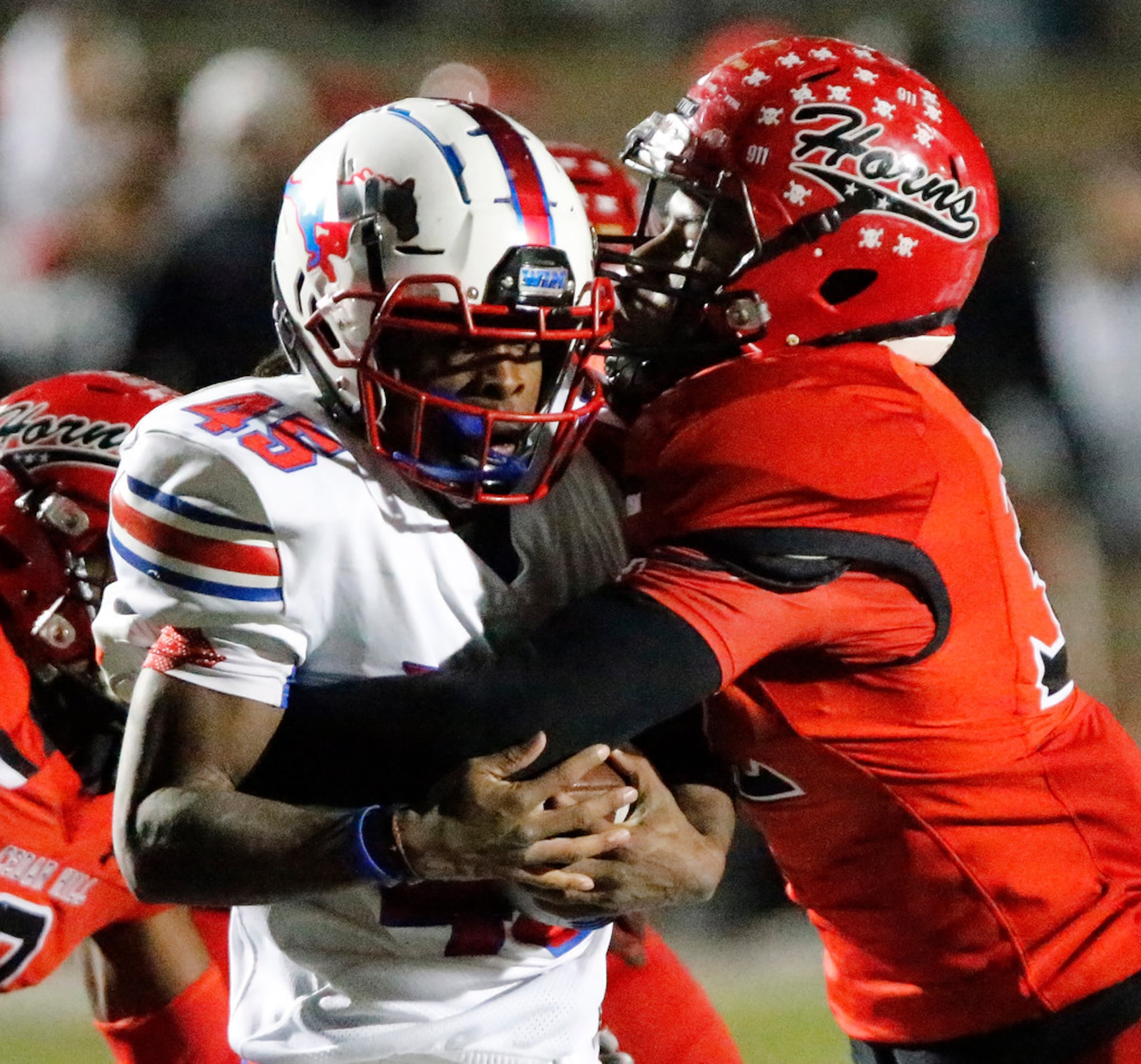 Pearce High School running back Dequan Landon (45) is met by Cedar Hill High School...