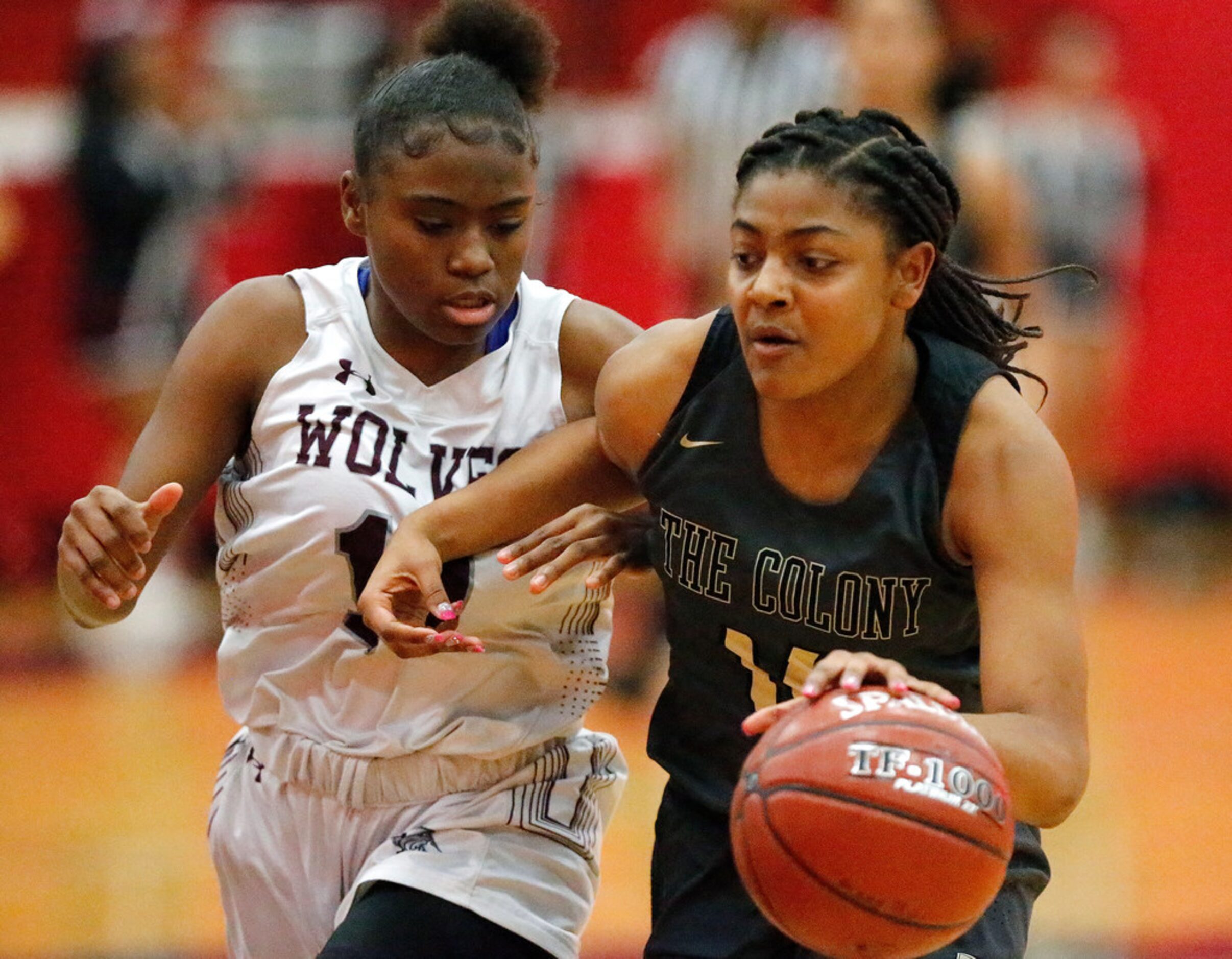 The Colony High School Tamia Jones (14) drives to the basket while Timberview High School...