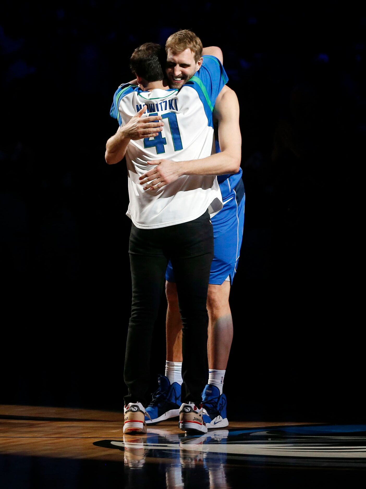 April 9, 2019: Dallas Mavericks forward Dirk Nowitzki (41) hugs owner Mark Cuban during a...