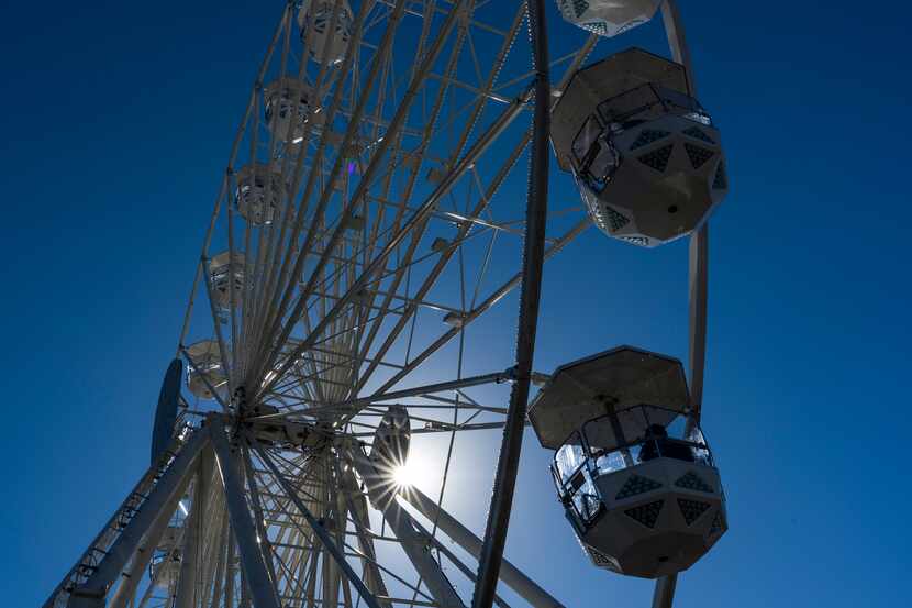 The sun filters through a ferris wheel (not the Texas Star) at the State Fair of Texas on...