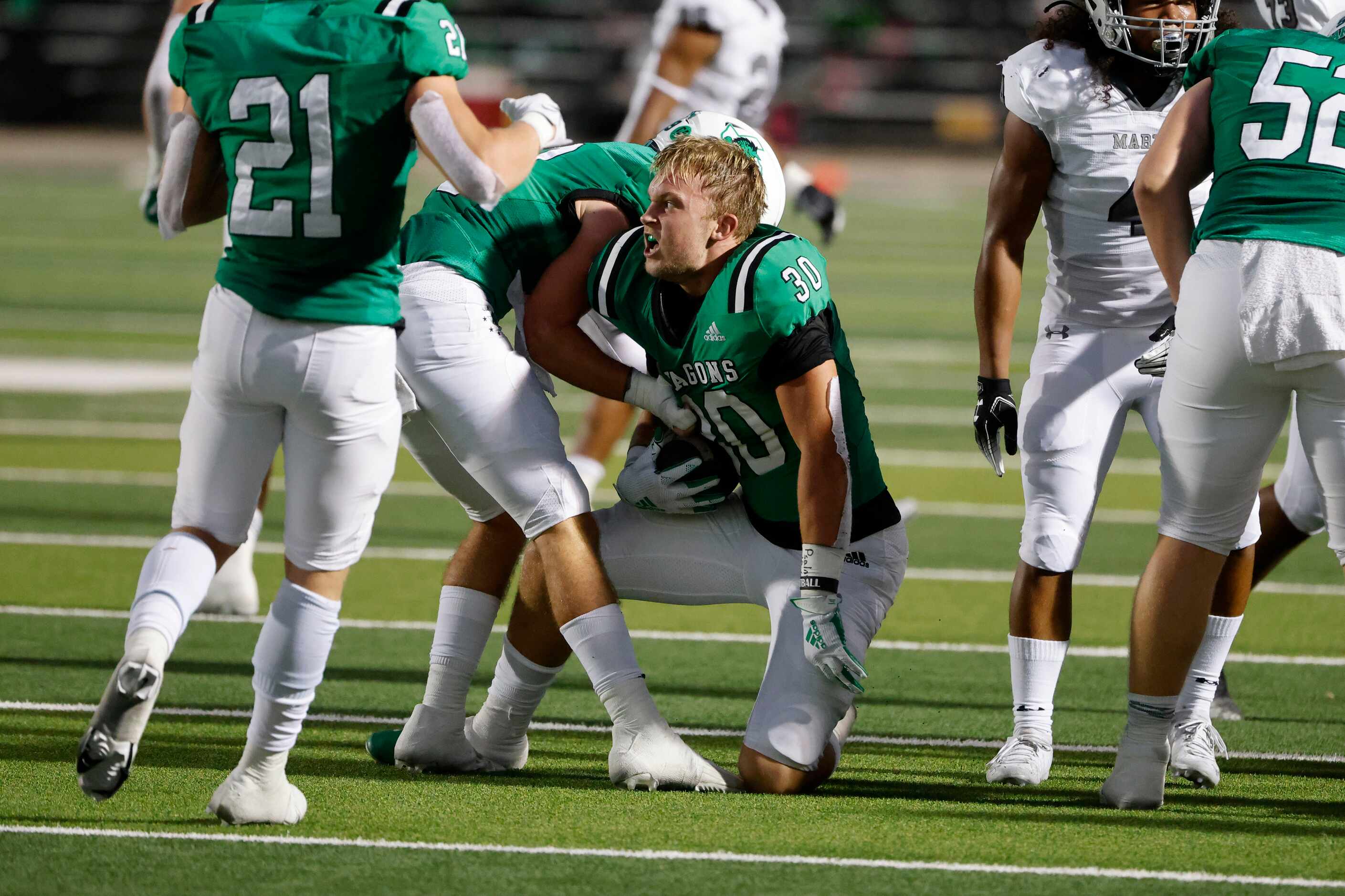 Southlake Carroll linebacker Nate Gall (30) celebrates his interception against Arlington...