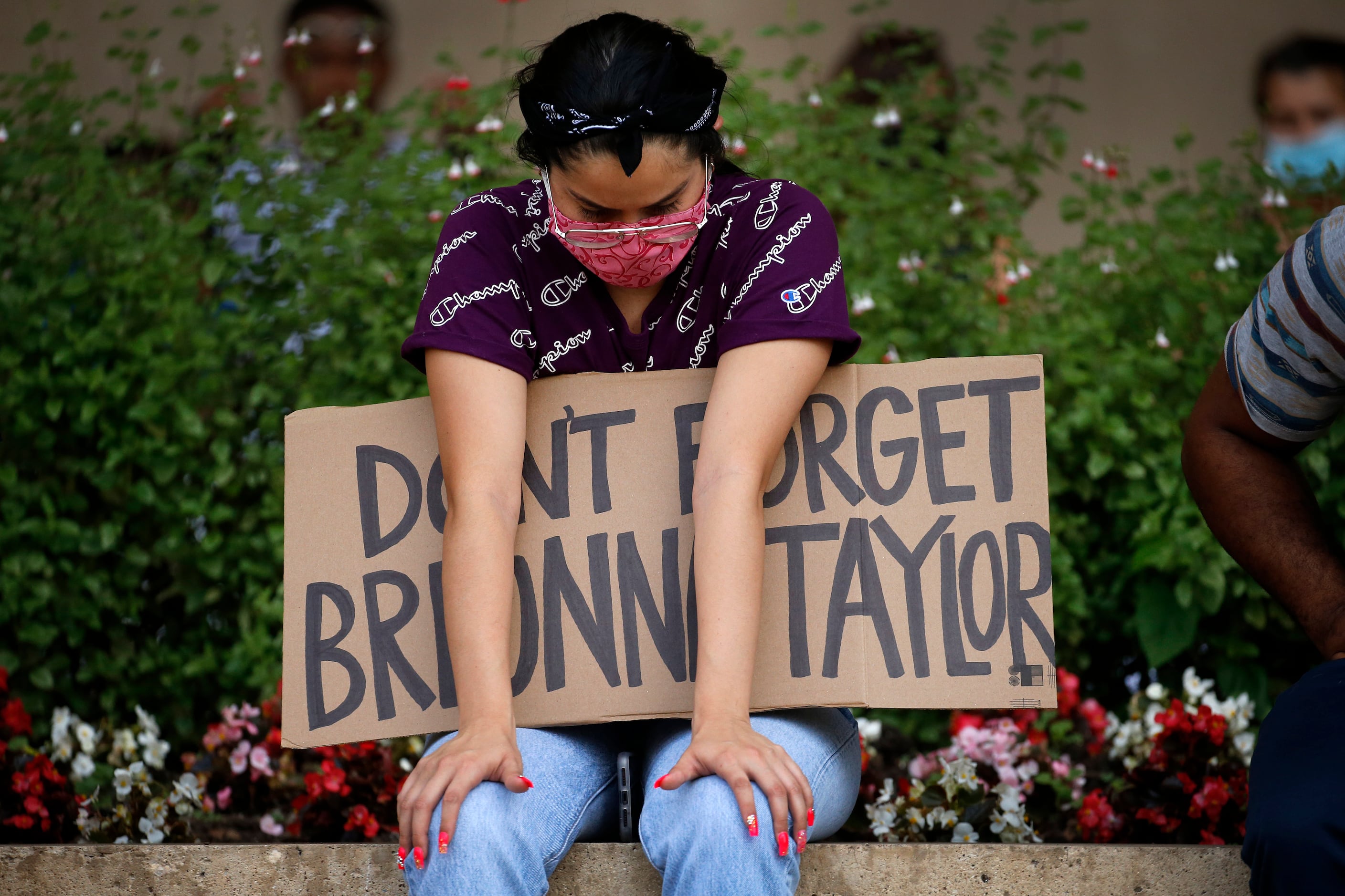 A protestor supporting Breonna Taylor came to listen to a Black Lives Matters rally at...