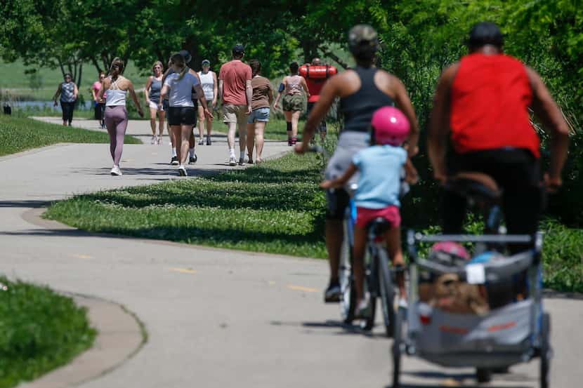 At 1:45 p.m. people walk and bike around White Rock Lake on April 24, 2020 in Dallas.
