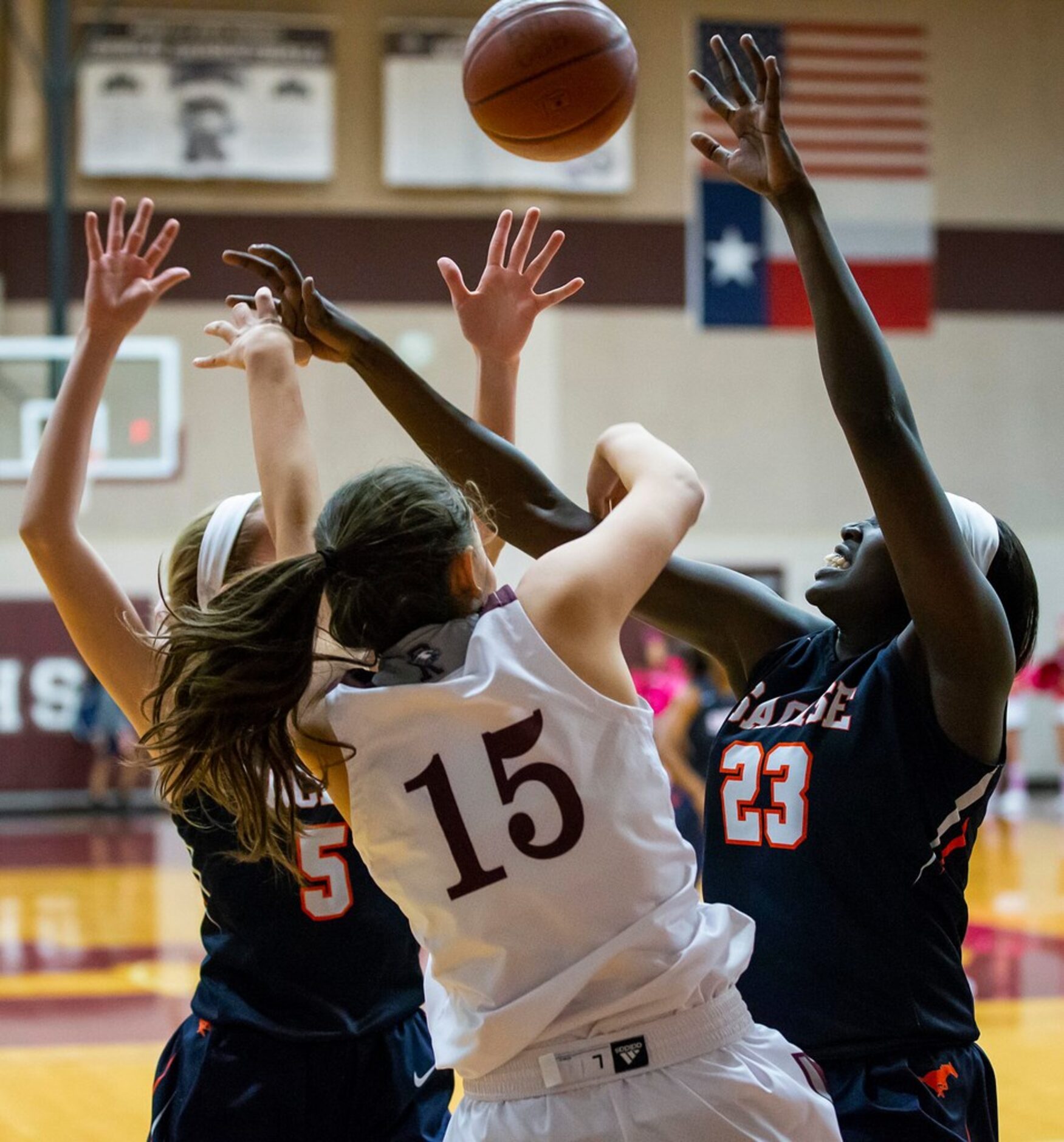 Sachse center Adhel Tac (23) and guard Avery Crouse (5) trap Rowlett guard Madi Rodriguez...