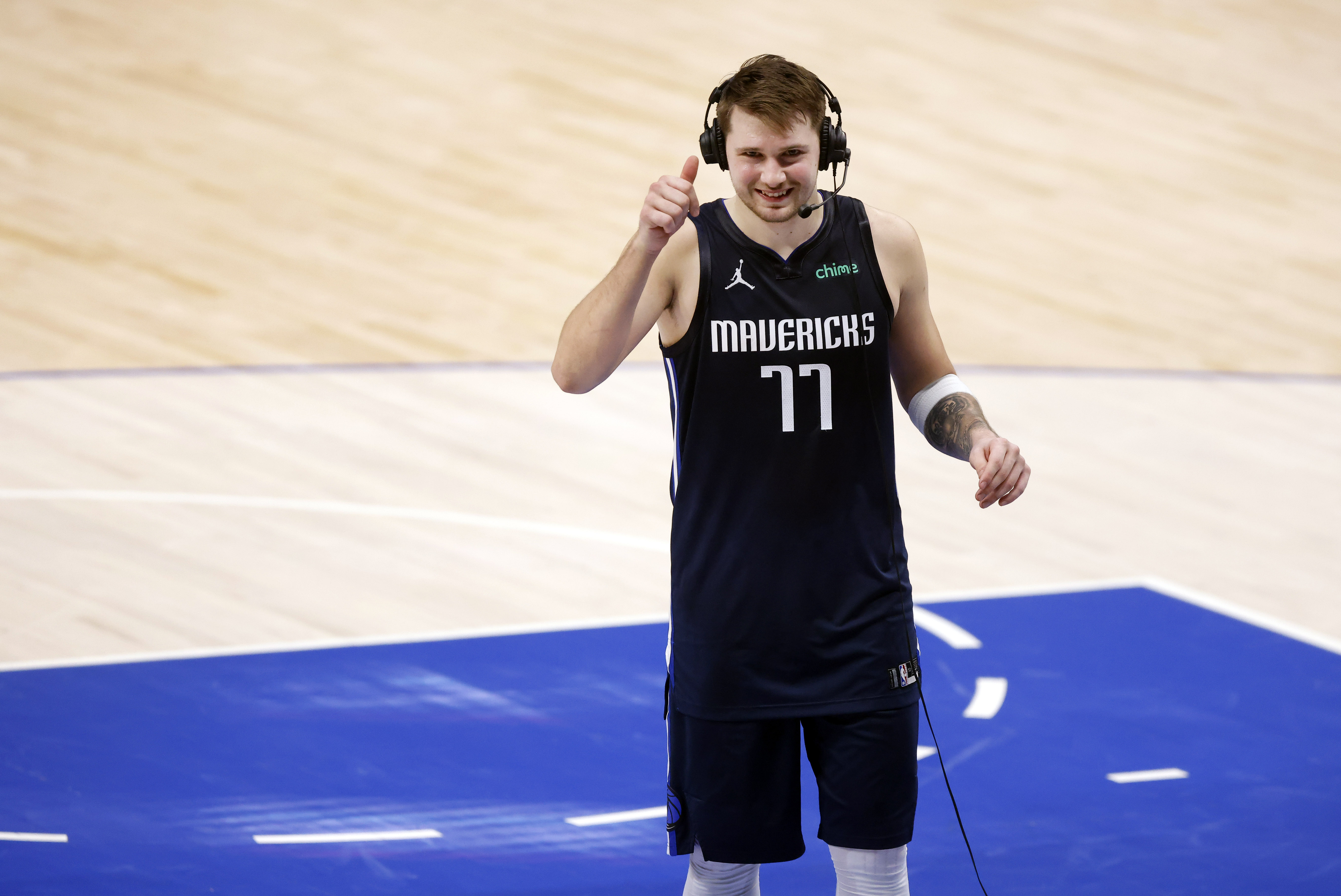 Dallas Mavericks guard Luka Doncic (77) gives a thumbs up to the television camera as he...