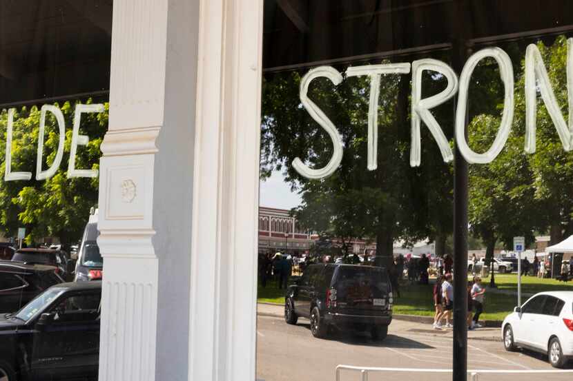 Uvalde Strong written on the window at The Uvalde Grand Opera House in memory of the 19...