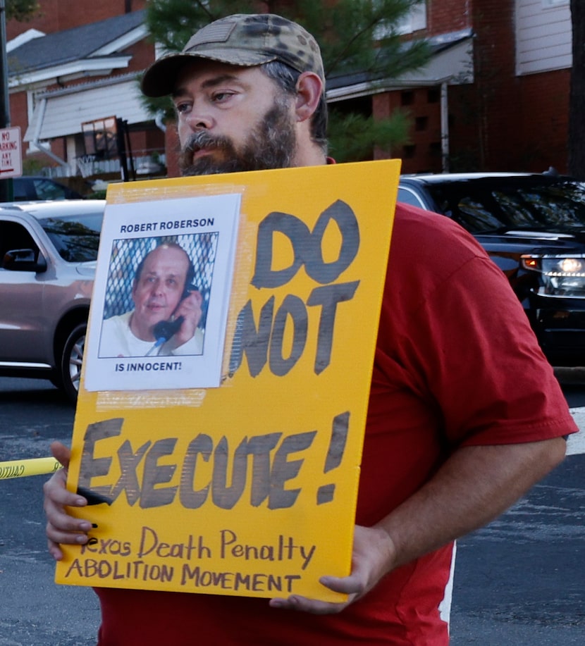 Thomas Roberson, a brother of Robert Roberson holds a sign in front of Huntsville Unit,...